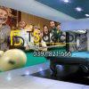 Young men and women playing billiards at office after work.